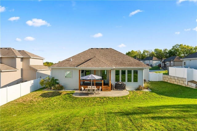 back of house with a yard and a patio area