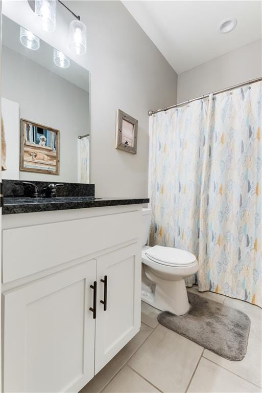 bathroom with tile patterned floors, toilet, and vanity