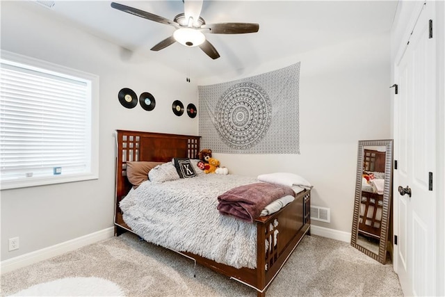 carpeted bedroom with ceiling fan