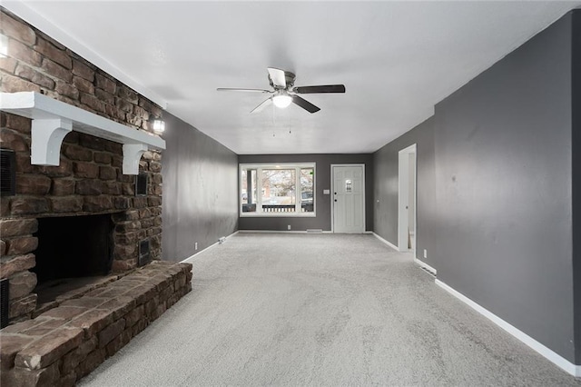 carpeted living room with a fireplace and ceiling fan