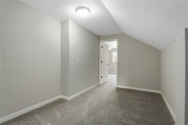 additional living space featuring lofted ceiling and carpet floors