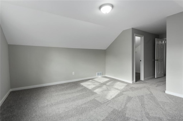 bonus room featuring light carpet and lofted ceiling