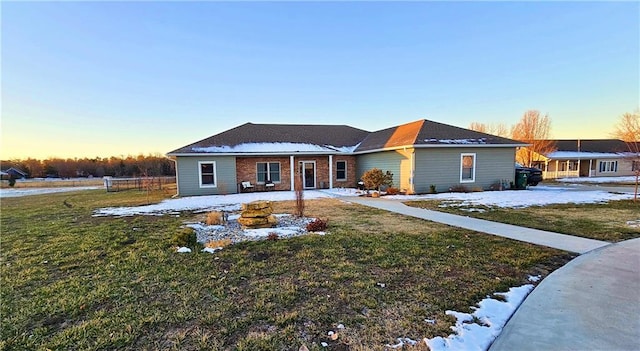 ranch-style home featuring a lawn