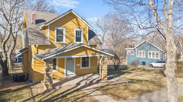 view of front of property with covered porch and central air condition unit