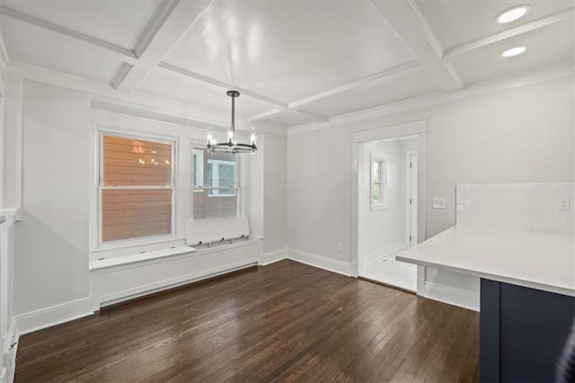 unfurnished dining area with a notable chandelier, dark hardwood / wood-style flooring, coffered ceiling, and beamed ceiling