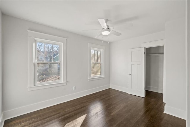 unfurnished bedroom with ceiling fan, a closet, and dark hardwood / wood-style floors