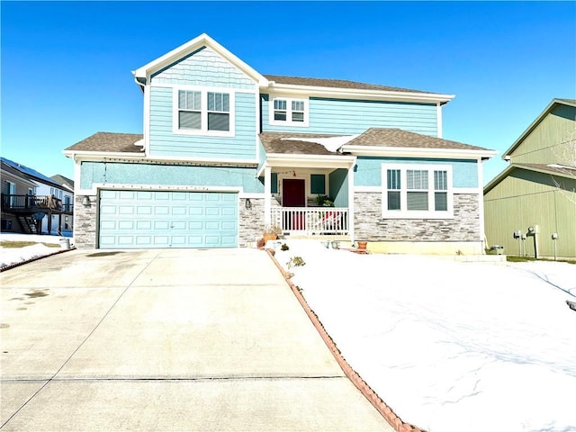 view of front of property featuring covered porch and a garage