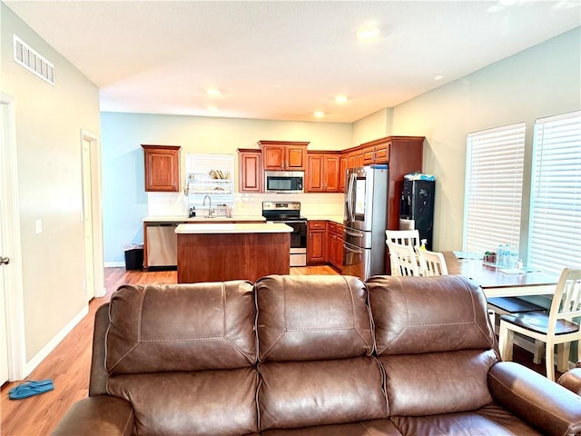 living room featuring light hardwood / wood-style flooring and sink