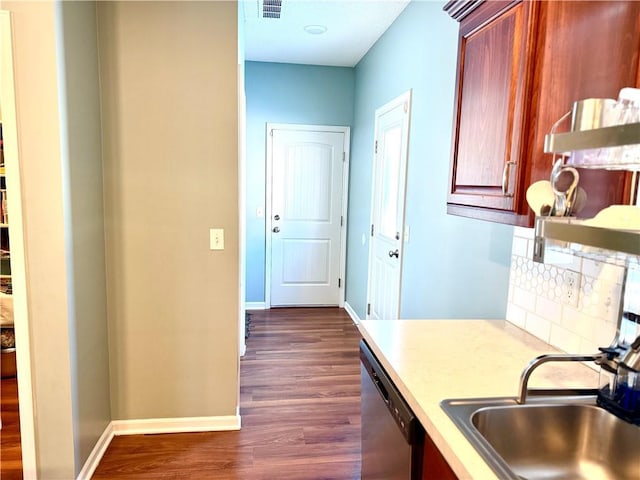 kitchen with stainless steel dishwasher, sink, tasteful backsplash, and dark hardwood / wood-style floors