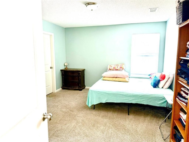 carpeted bedroom with a textured ceiling