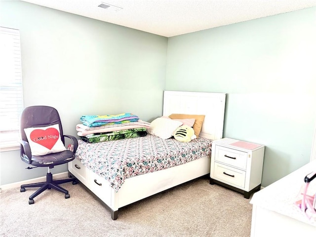 bedroom featuring light colored carpet