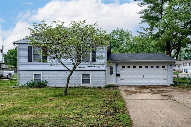 split level home featuring a garage and a front lawn