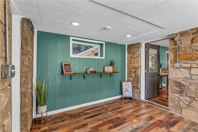 interior space featuring a textured ceiling and hardwood / wood-style floors