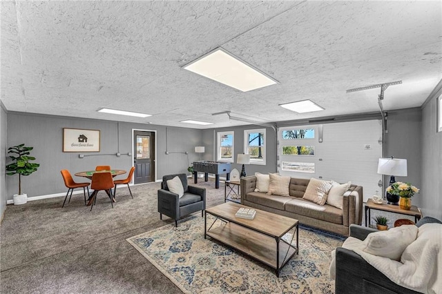 living room with a textured ceiling and carpet