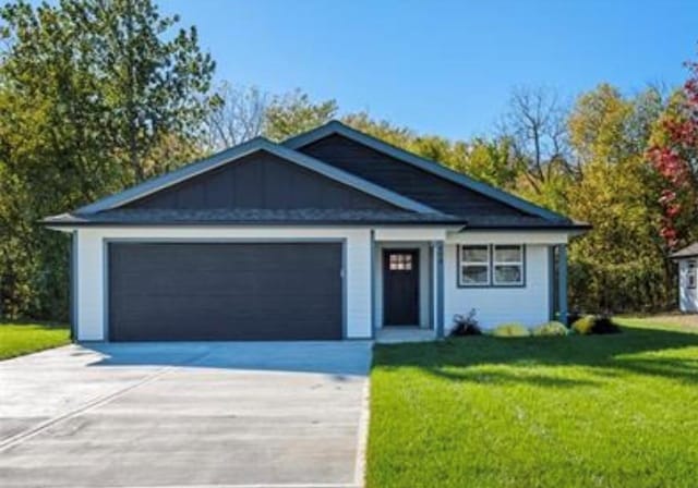 view of front of home with a front lawn and a garage