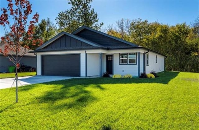 ranch-style home featuring a garage and a front yard