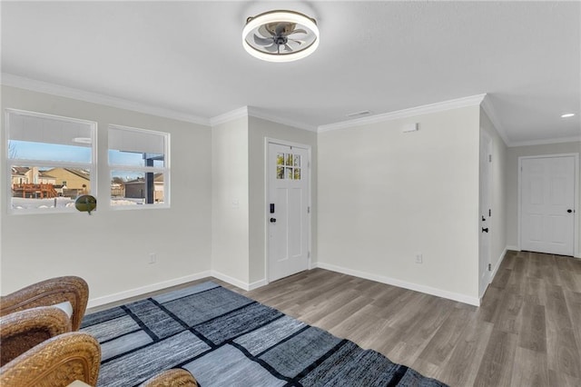 entrance foyer with ceiling fan, light hardwood / wood-style flooring, and ornamental molding