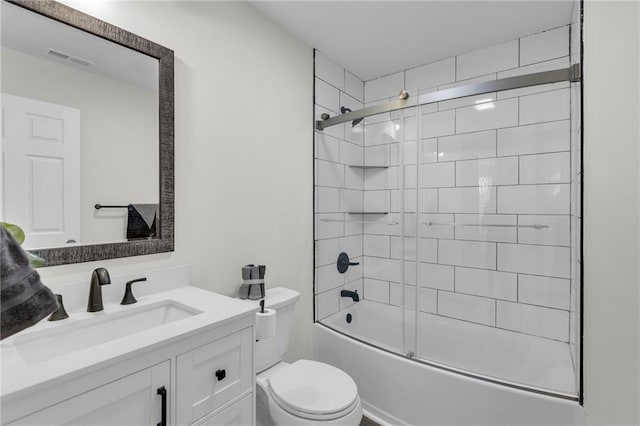 full bathroom featuring combined bath / shower with glass door, vanity, and toilet