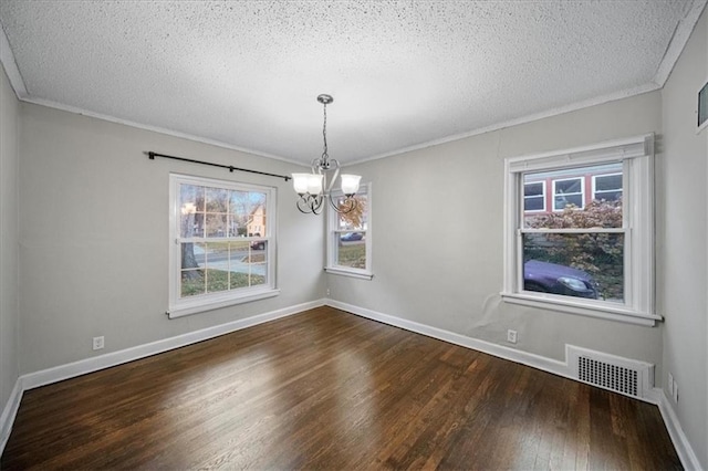 unfurnished dining area with a notable chandelier, plenty of natural light, crown molding, and dark hardwood / wood-style floors