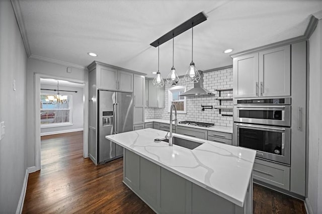 kitchen featuring sink, stainless steel appliances, gray cabinetry, and light stone countertops