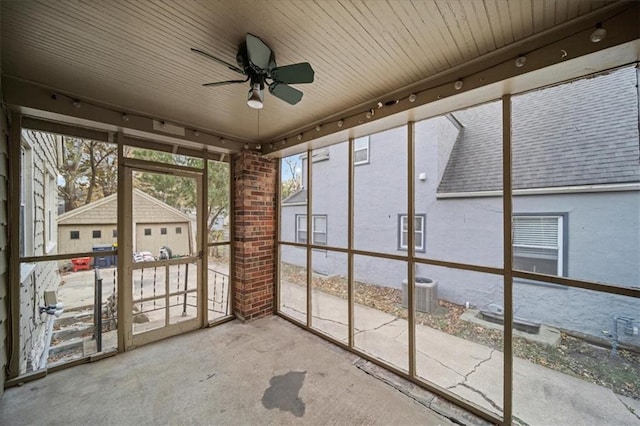 unfurnished sunroom with ceiling fan