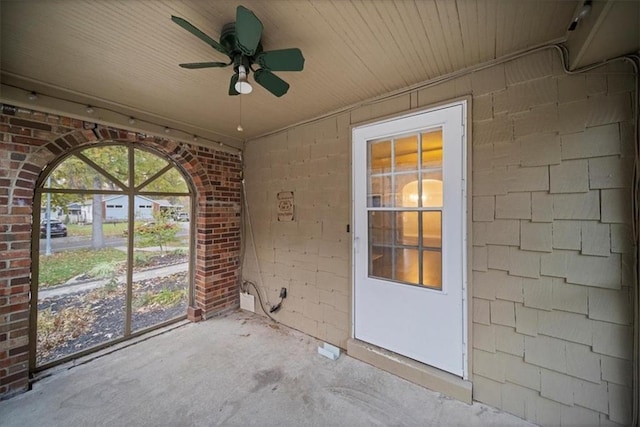 unfurnished sunroom with ceiling fan and wood ceiling