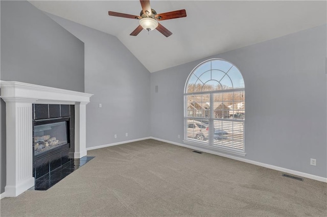 unfurnished living room featuring carpet flooring, a fireplace, ceiling fan, and vaulted ceiling