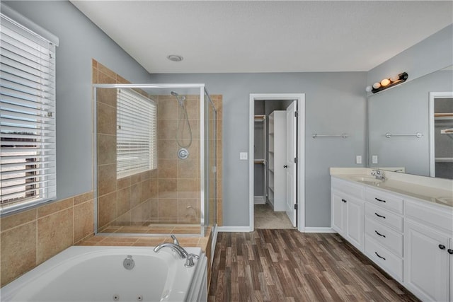 bathroom featuring hardwood / wood-style floors, independent shower and bath, and vanity