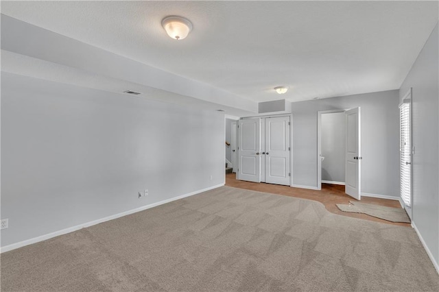 unfurnished bedroom featuring light colored carpet