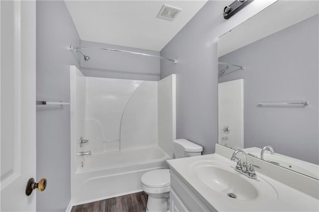 full bathroom featuring wood-type flooring, shower / bathtub combination, vanity, and toilet