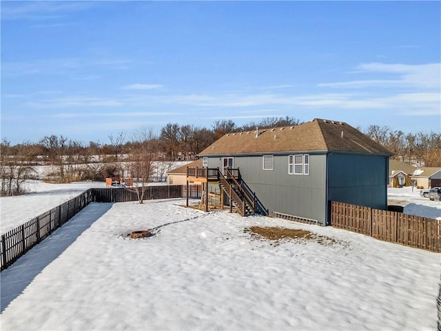 snowy yard with a wooden deck