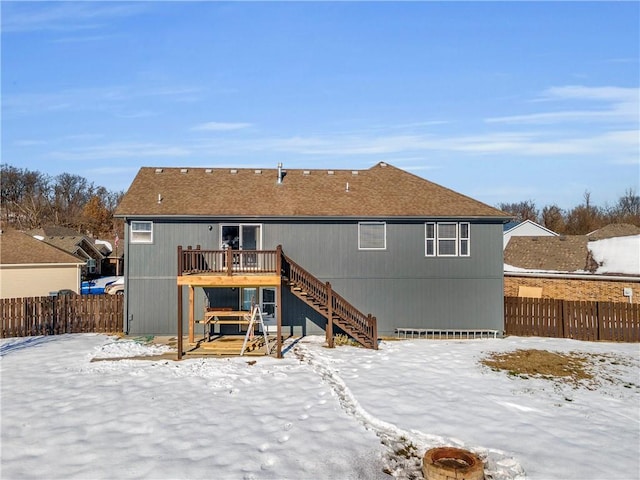 snow covered property with a wooden deck