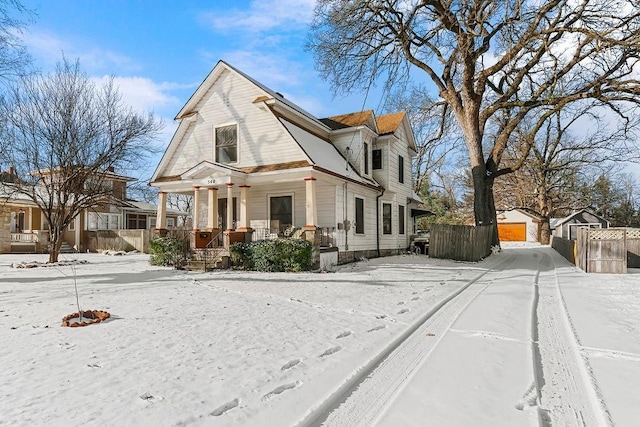 view of front of house featuring an outbuilding, a garage, and covered porch