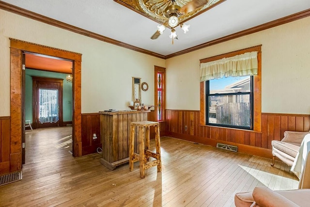 interior space featuring hardwood / wood-style flooring, ornamental molding, and a chandelier