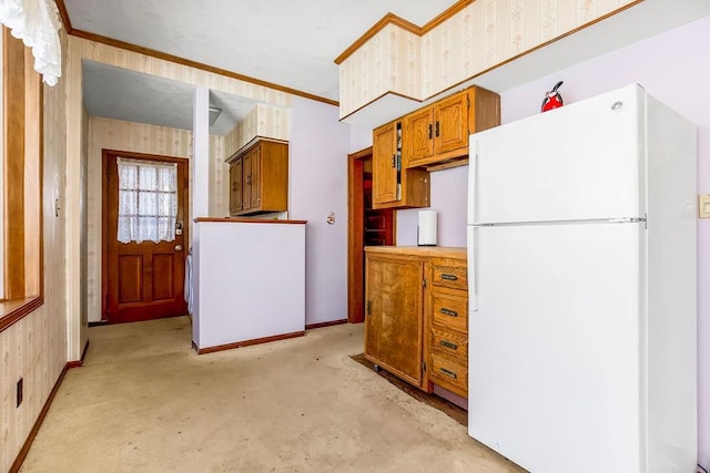 kitchen with crown molding and white fridge