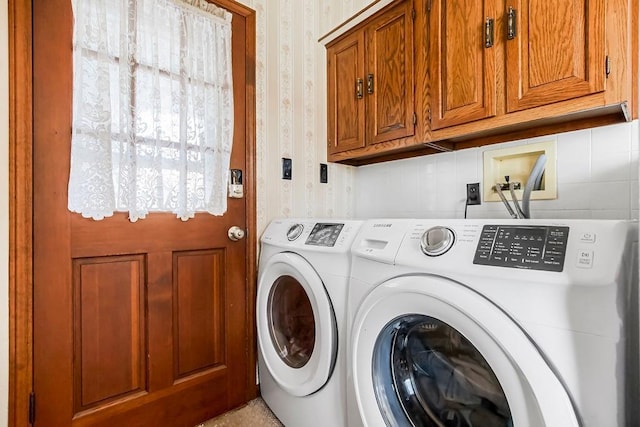 laundry area featuring independent washer and dryer and cabinets