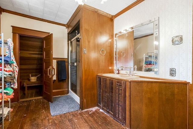 bathroom featuring hardwood / wood-style flooring, ornamental molding, and vanity