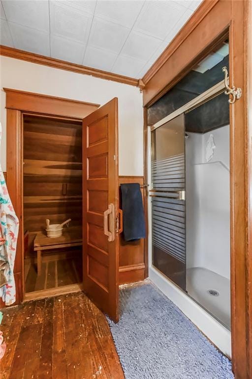 bathroom with ornamental molding and hardwood / wood-style floors