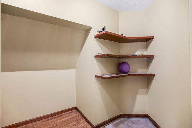 spacious closet featuring hardwood / wood-style flooring