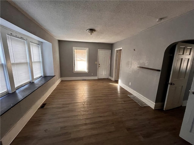 interior space featuring dark hardwood / wood-style flooring and a textured ceiling