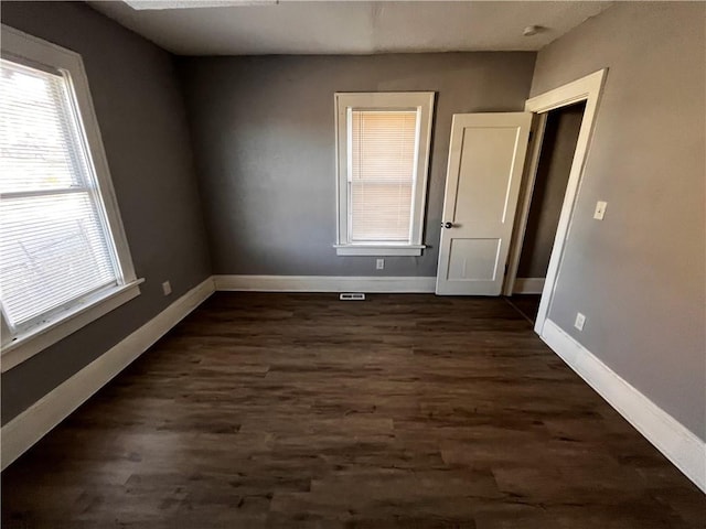 spare room with dark hardwood / wood-style flooring