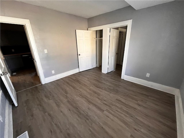 unfurnished bedroom featuring dark hardwood / wood-style floors