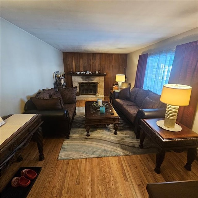 living room with a fireplace and wood-type flooring