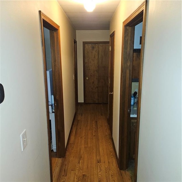 hallway with hardwood / wood-style flooring