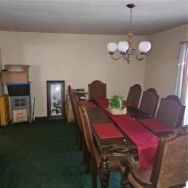 dining room featuring a chandelier and dark carpet