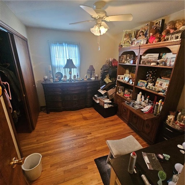 bedroom with ceiling fan, light hardwood / wood-style flooring, and a closet