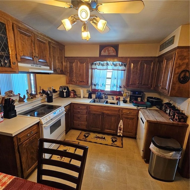 kitchen with sink, ceiling fan, and white electric range