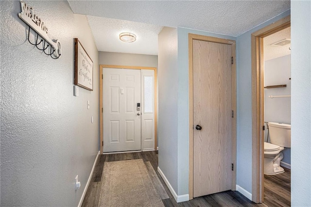 interior space with dark wood-type flooring and a textured ceiling