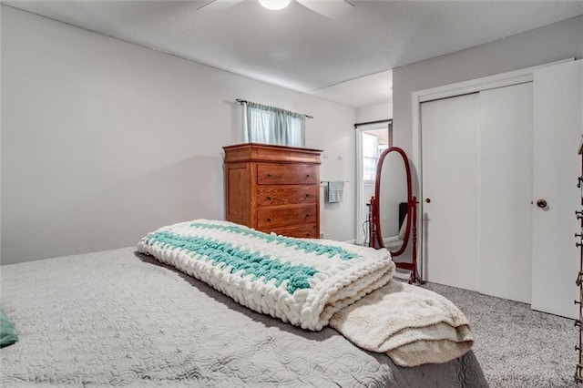 carpeted bedroom featuring ceiling fan and a closet