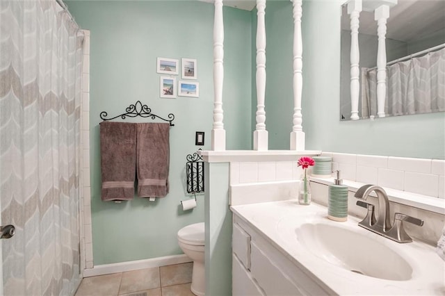 bathroom with toilet, tile patterned flooring, a shower with curtain, and vanity